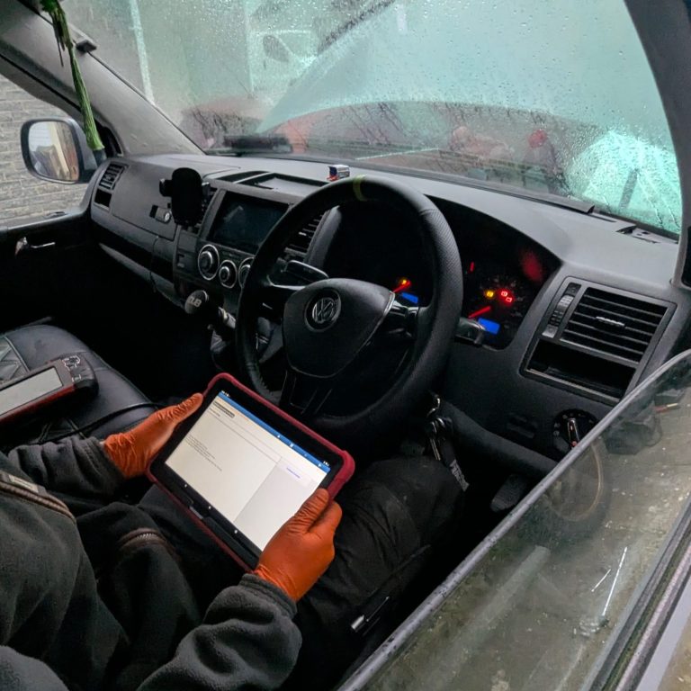 kia-rio-engine-management-light-diagnostics AJ AGRI van on-site diagnosing an engine management light (EML) fault on a Kia Rio with its bonnet up.