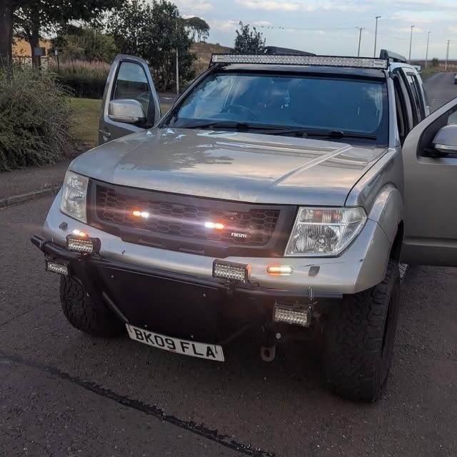 AJ AGRI wiring rooftop lightbar, front spotlights, and grill beacons on a 2009 Nissan Pathfinder 4x4.